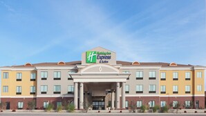 A Holiday Inn Express & Suites hotel with a symmetrical facade, multiple windows, and a central entrance. - Holiday Inn Express Hotel & Suites Brownfield by IHG (Brownfield)
