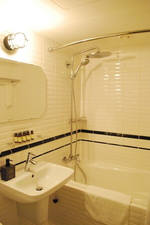 Combined shower/tub, free toiletries, hair dryer, slippers