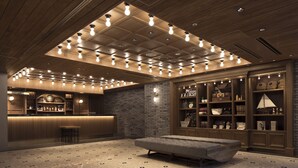 A spacious lobby with a reception desk, a bar area, and a seating area with a bench. - Hotel The Knot Yokohama (Yokohama)