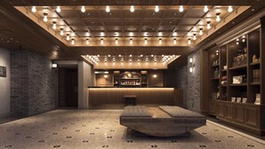 A lobby with a reception desk, a bench, and a wall with shelves. - Hotel The Knot Yokohama (Yokohama)