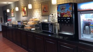 A breakfast bar with a coffee machine, a fruit juice dispenser, and a yogurt cooler. - Best Western Plus Goodman Inn & Suites (Horn Lake)