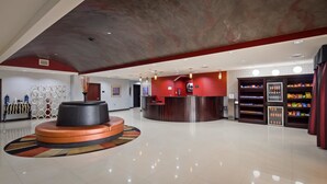 A spacious lobby with a reception desk, a large circular seating area, and a snack vending machine. - Best Western Plus Goodman Inn & Suites (Horn Lake)