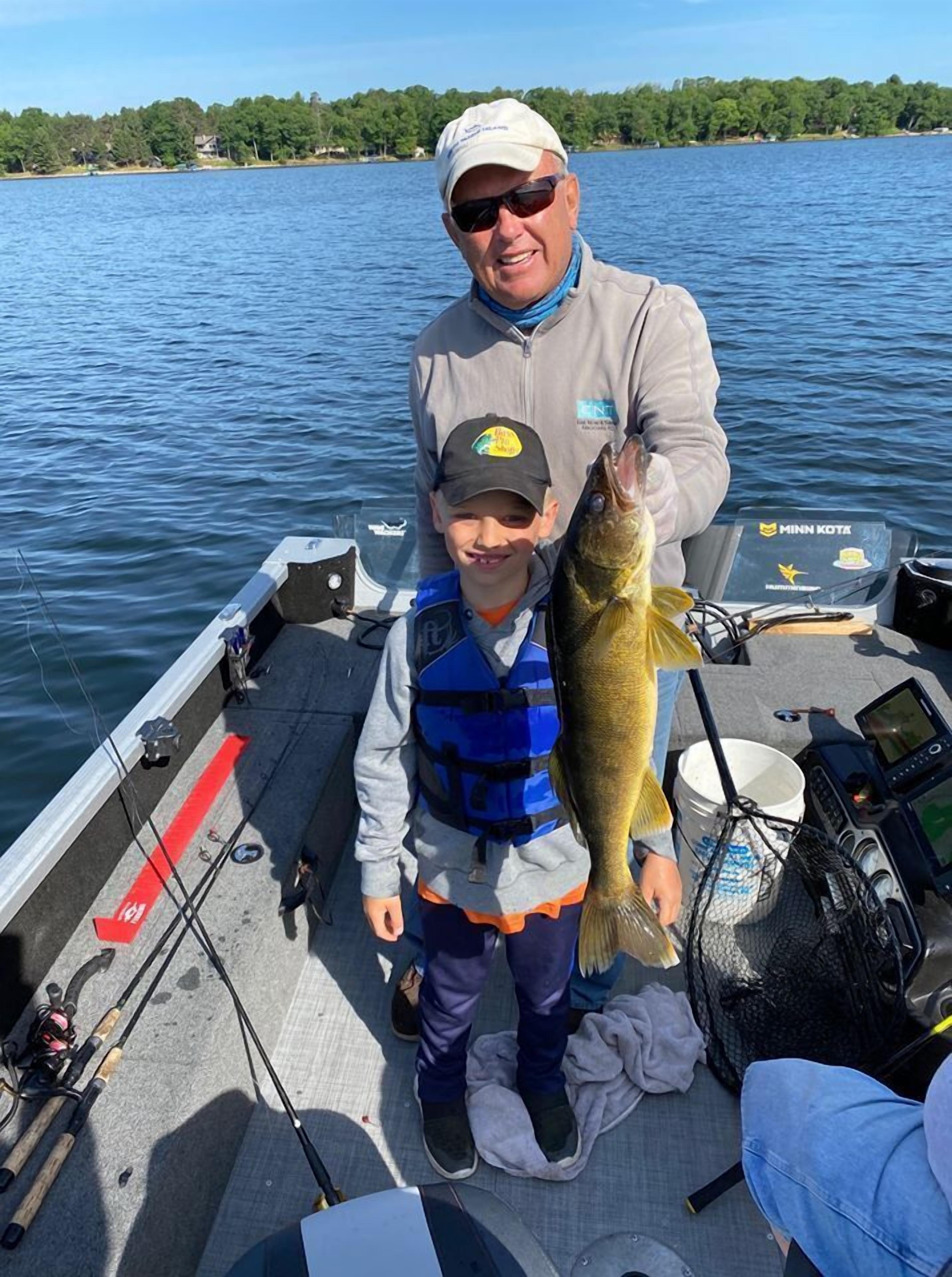 A boat with a Minn Kota outboard motor, fishing rods, and a catch.
