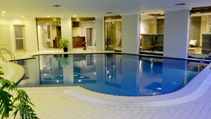 An indoor swimming pool with clear water, surrounded by tiled walls and a tiled floor. - Spice Boutique Hotel (Salmiya)