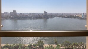 A cityscape with a river, buildings, and a bridge. - Fairmont Nile City, Cairo (Cairo)