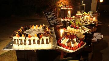 A dessert buffet with various cakes and pastries displayed on tables.