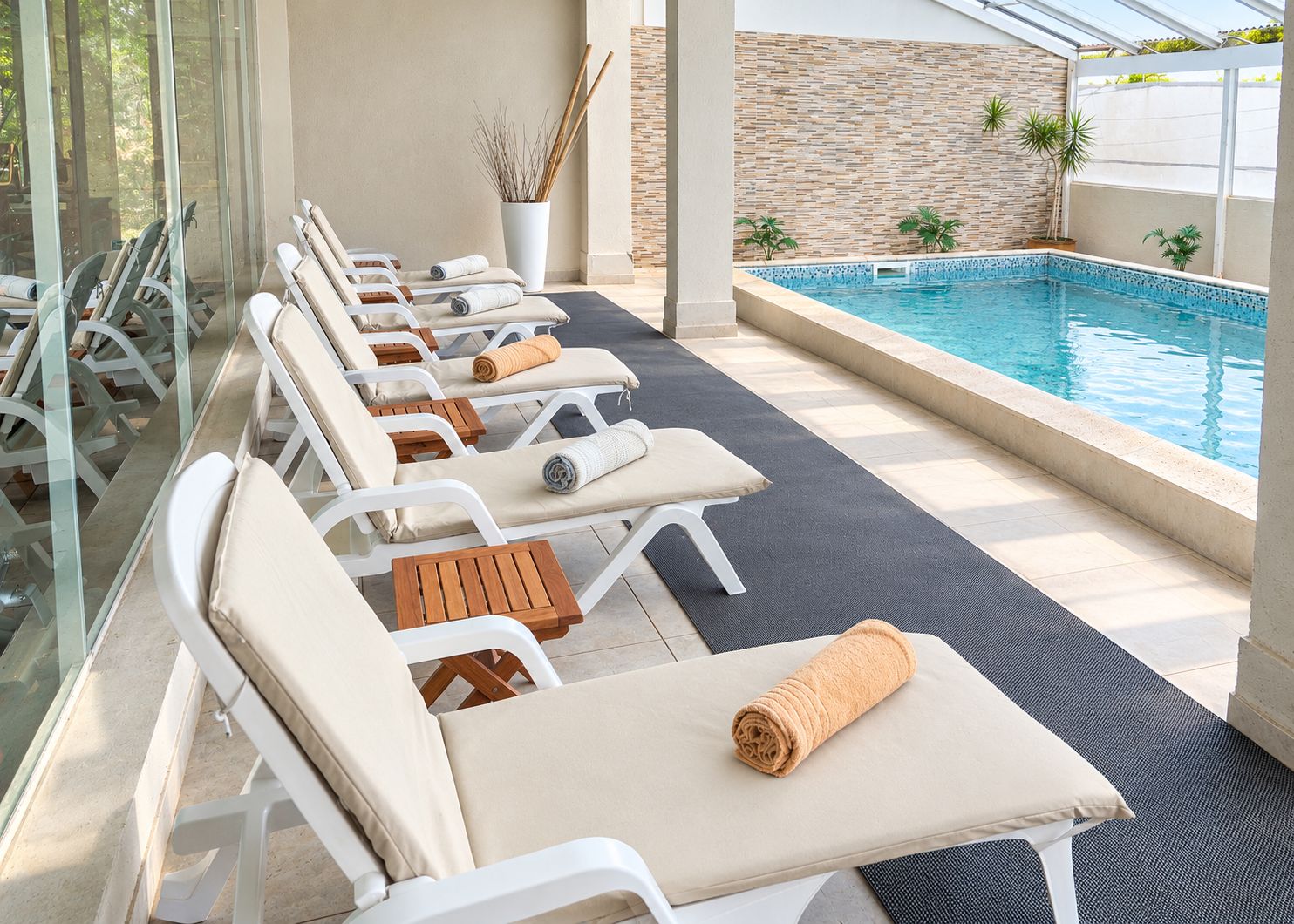 A poolside area with lounge chairs and a small pool.