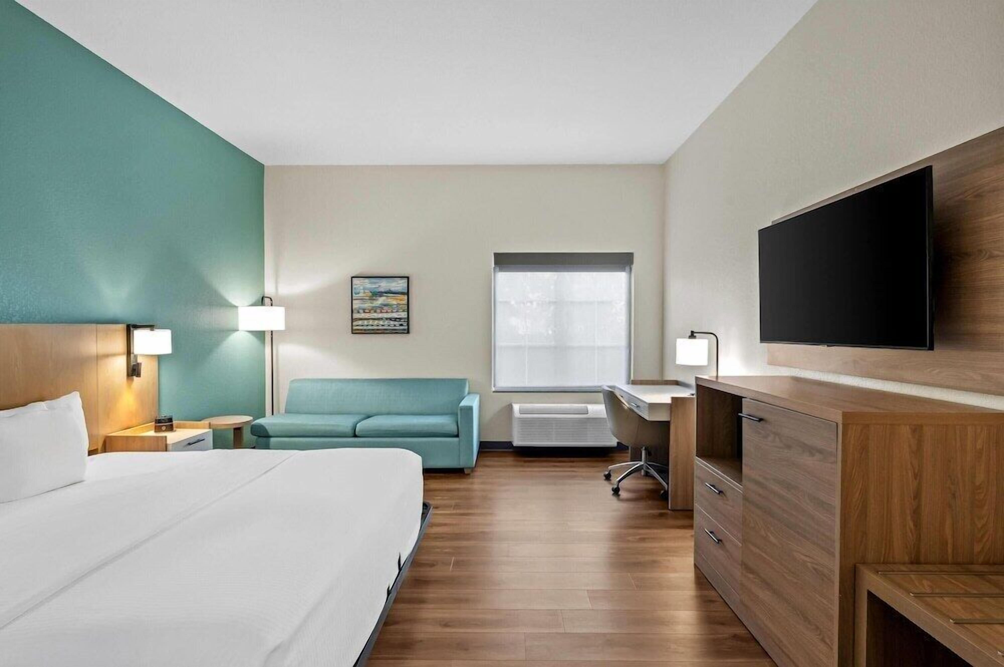 Premium bedding, desk, laptop workspace, soundproofing