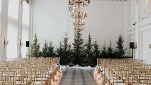 A grand hall with a geometric patterned floor, rows of wooden chairs, and a central chandelier. - The George Washington Hotel (Washington)
