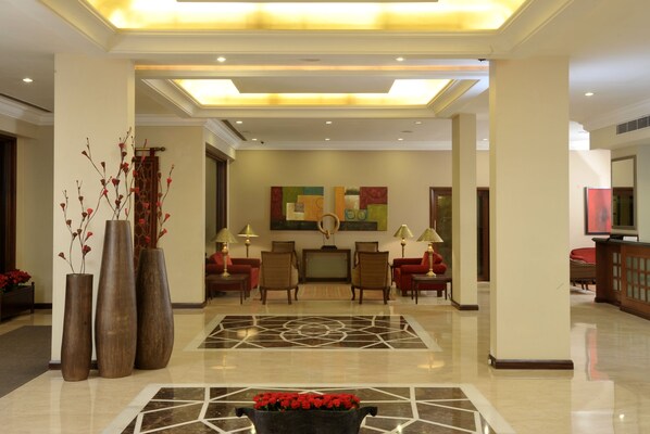 A spacious lobby with a polished floor, a reception desk, and seating areas. - Hotel Express Towers (Vadodara)
