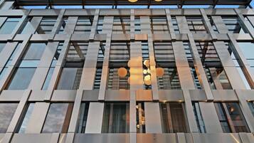A modern building with a glass facade and a visible Hilton Garden Inn sign.