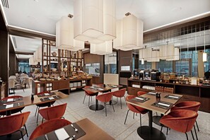 Guests can relax in a spacious lobby with comfortable seating and modern decor.