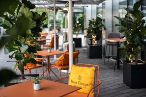 Enjoy dining al fresco amidst lush greenery and elegant seating.