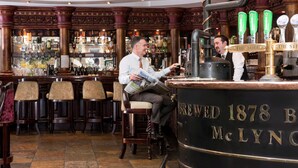 A bar with wooden decor, a large beer tap, and a sign reading "BREWED 1878 B McLYNO". - Four Seasons Hotel & Leisure Club Monaghan (Monaghan)