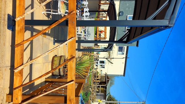 A wooden deck with a staircase, a white chair, and a small table. - Sportsmans Valley Hotel (Liskeard)