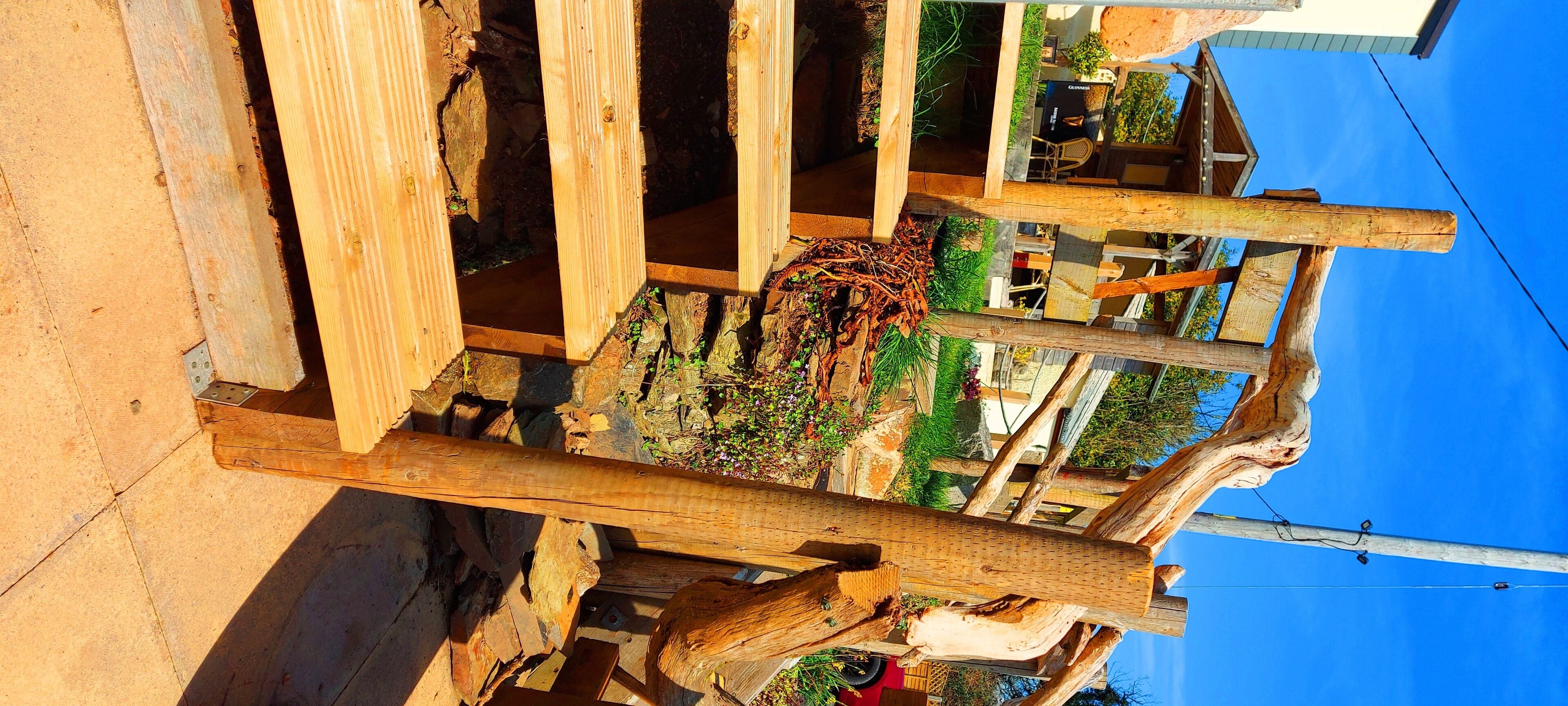 A wooden structure with a rustic design, featuring a mix of planks and beams.