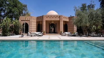 Outdoor pool, a heated pool, pool umbrellas, pool loungers