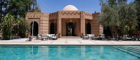 Outdoor pool, a heated pool, pool umbrellas, pool loungers
