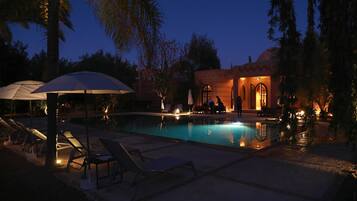 Outdoor pool, a heated pool, pool umbrellas, pool loungers