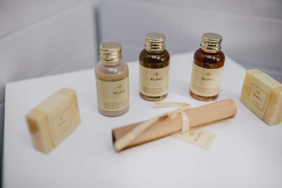 designer toiletries, hair dryer, towels