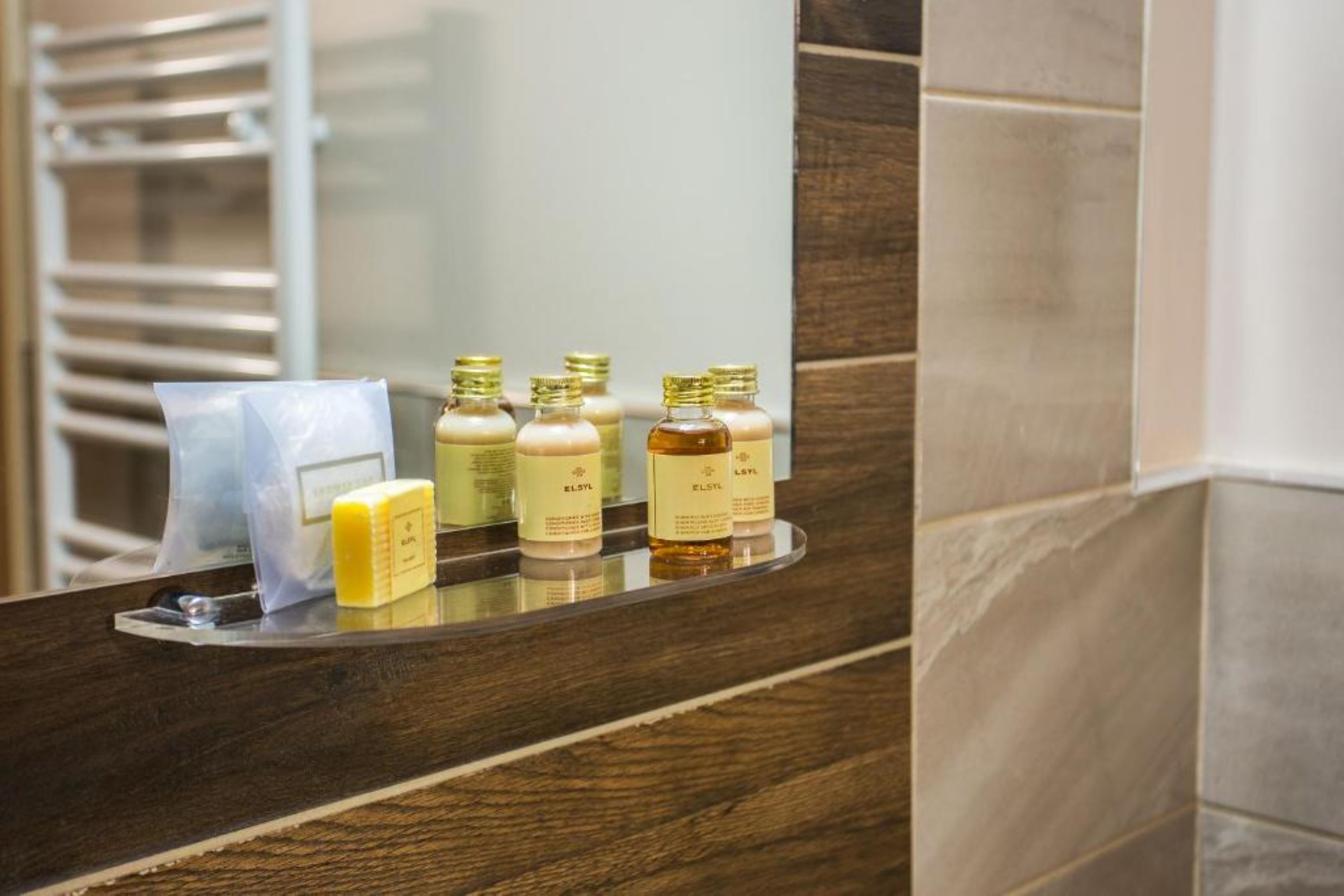 designer toiletries, hair dryer, towels