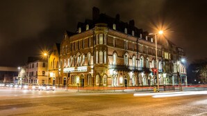 A historic building with arched windows and a corner entrance, labeled as a hotel. - Duke Of Edinburgh Hotel (Barrow-in-Furness)