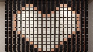 A modern interior with a geometric wall design and a tiled floor.