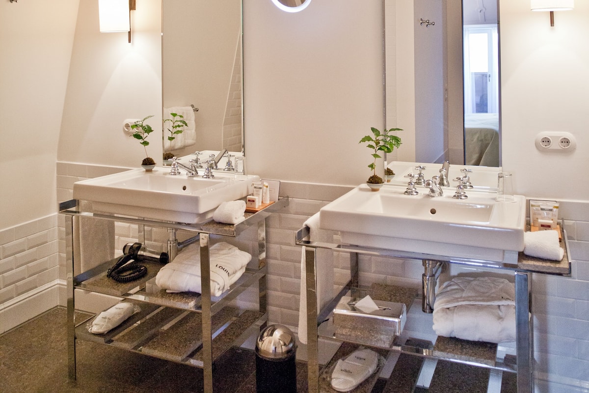 louis suite | bathroom | designer toiletries, hair dryer, bathrobes, slippers