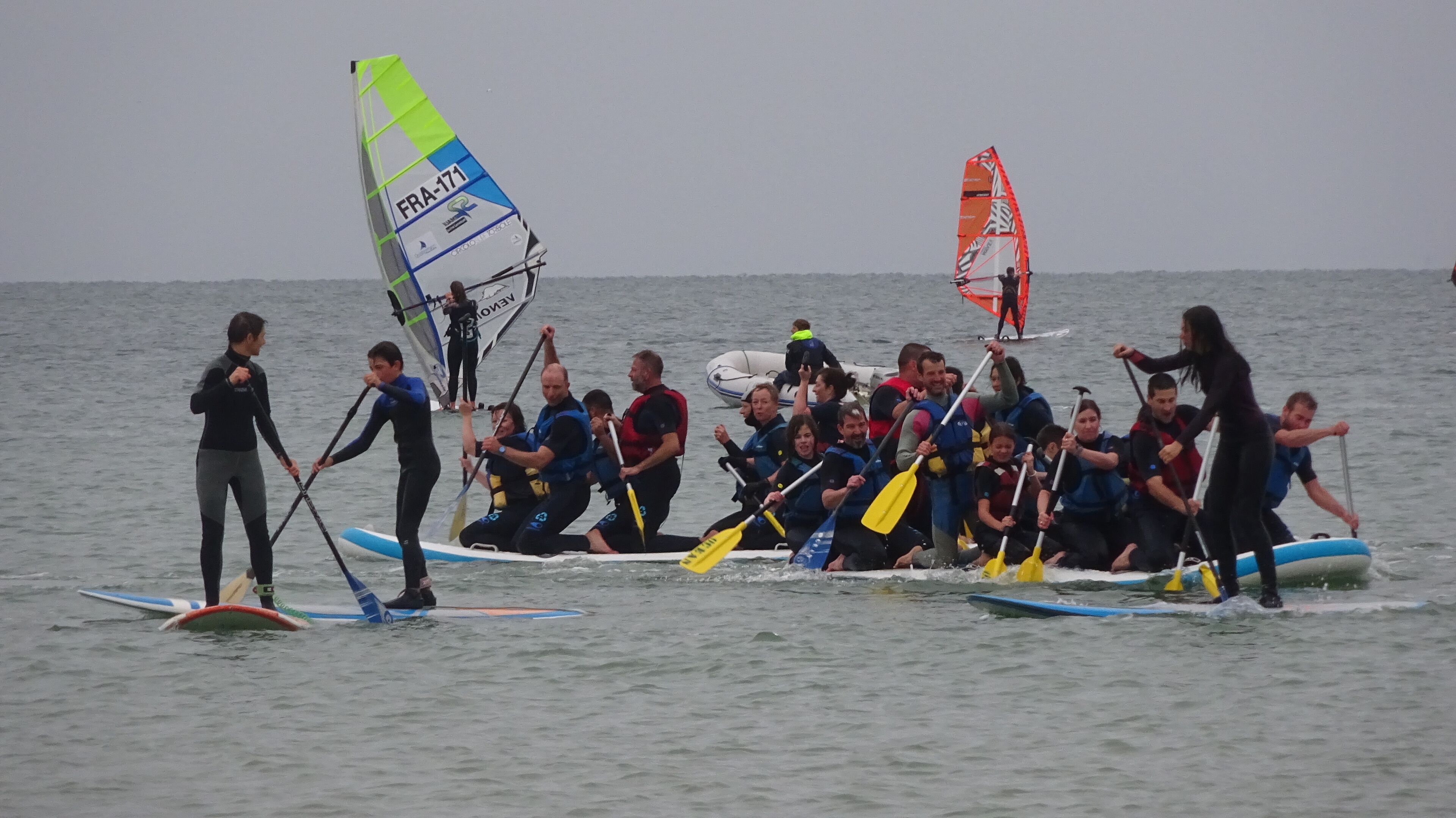 A group of people on paddleboards in a body of water.