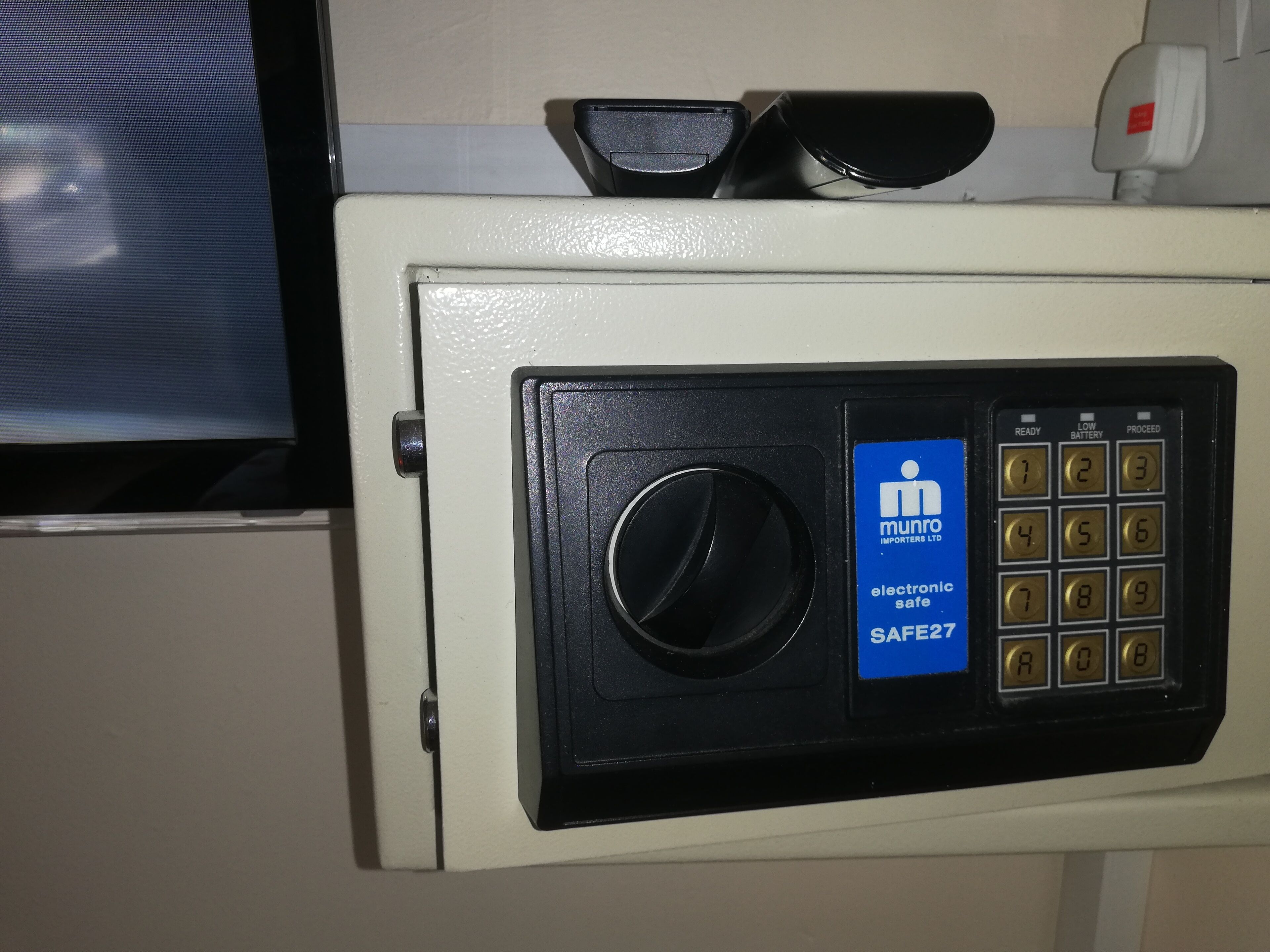 A safe with a digital keypad and a lock.