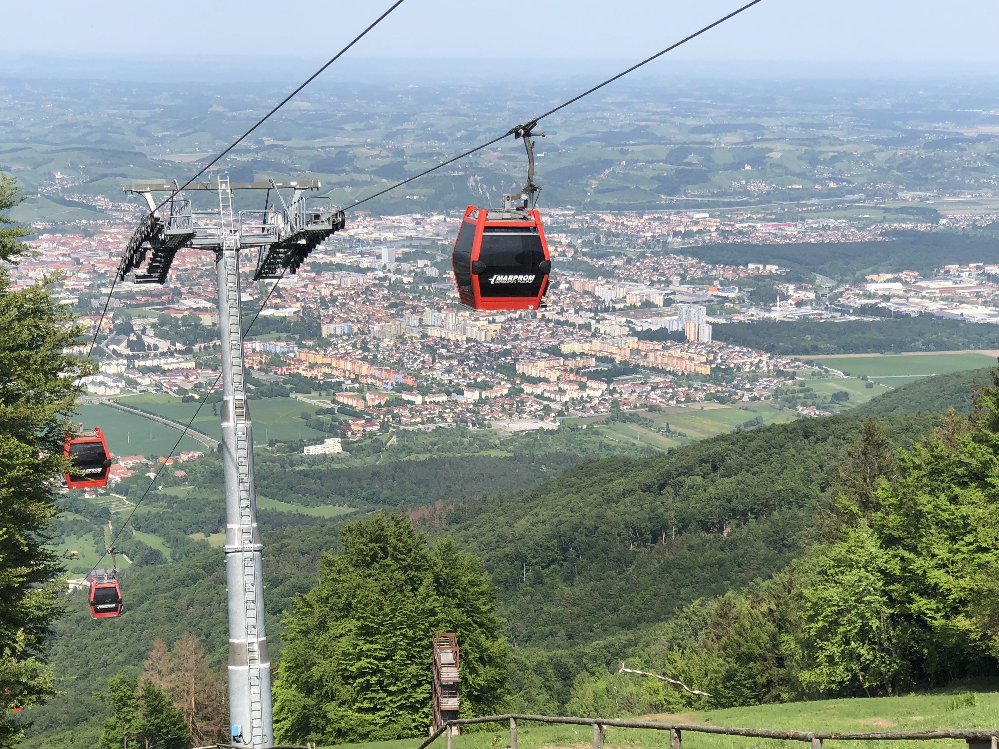 A cable car system with a cityscape in the background.