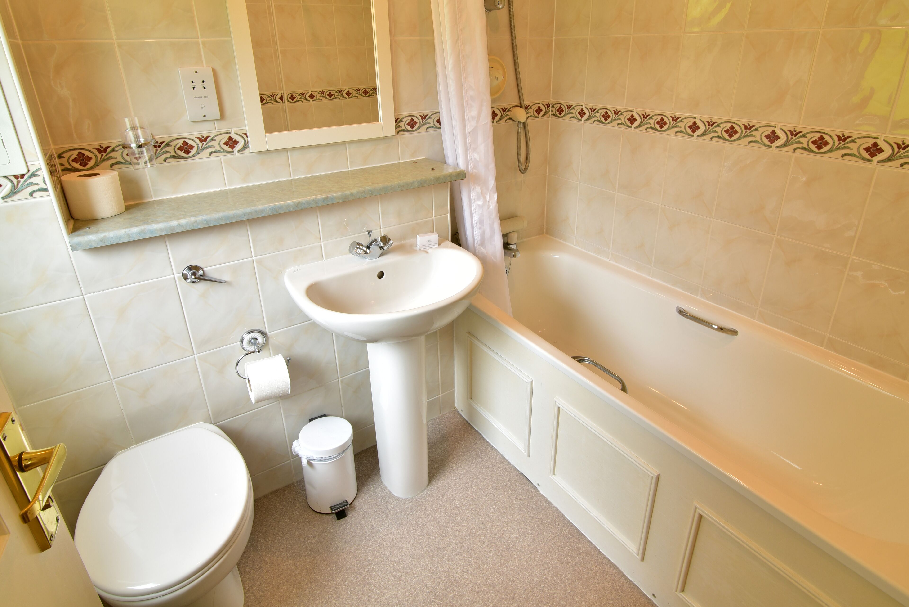 A bathroom with a toilet, sink, and bathtub.