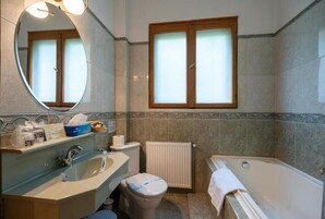 A bathroom with a sink, toilet, and bathtub.