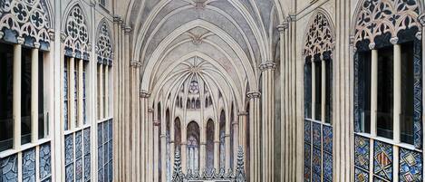 A Gothic-style interior with arched windows and a central stained glass window.