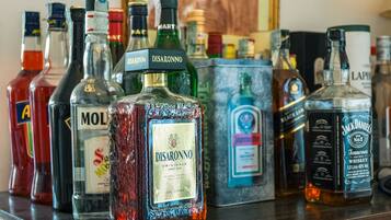 A variety of liquor bottles on a bar counter.