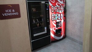 A vending machine with a Coca-Cola advertisement and a sign for 'Ice & Vending'. - Sleep Inn & Suites Highway 290/NW Freeway (Houston)