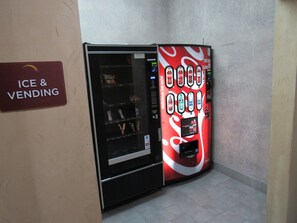 A vending machine with a Coca-Cola advertisement and a sign for 'Ice & Vending'. - Sleep Inn & Suites Highway 290/NW Freeway (Houston)
