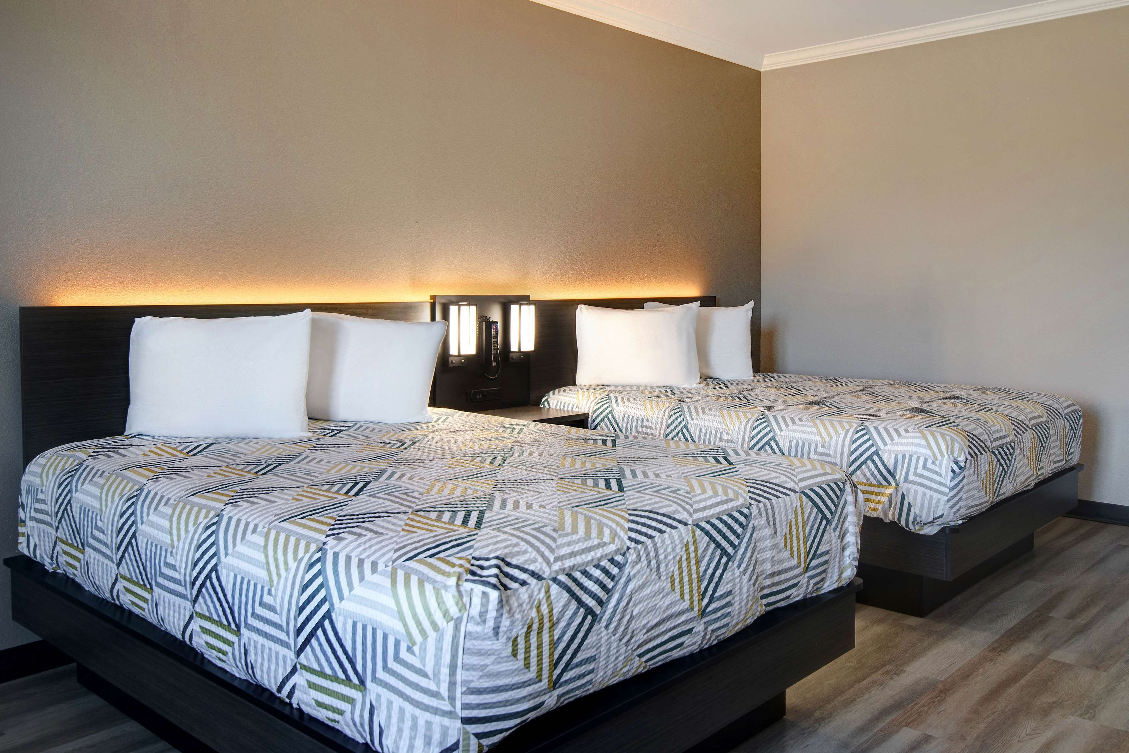 Premium bedding, pillow-top beds, desk, laptop workspace
