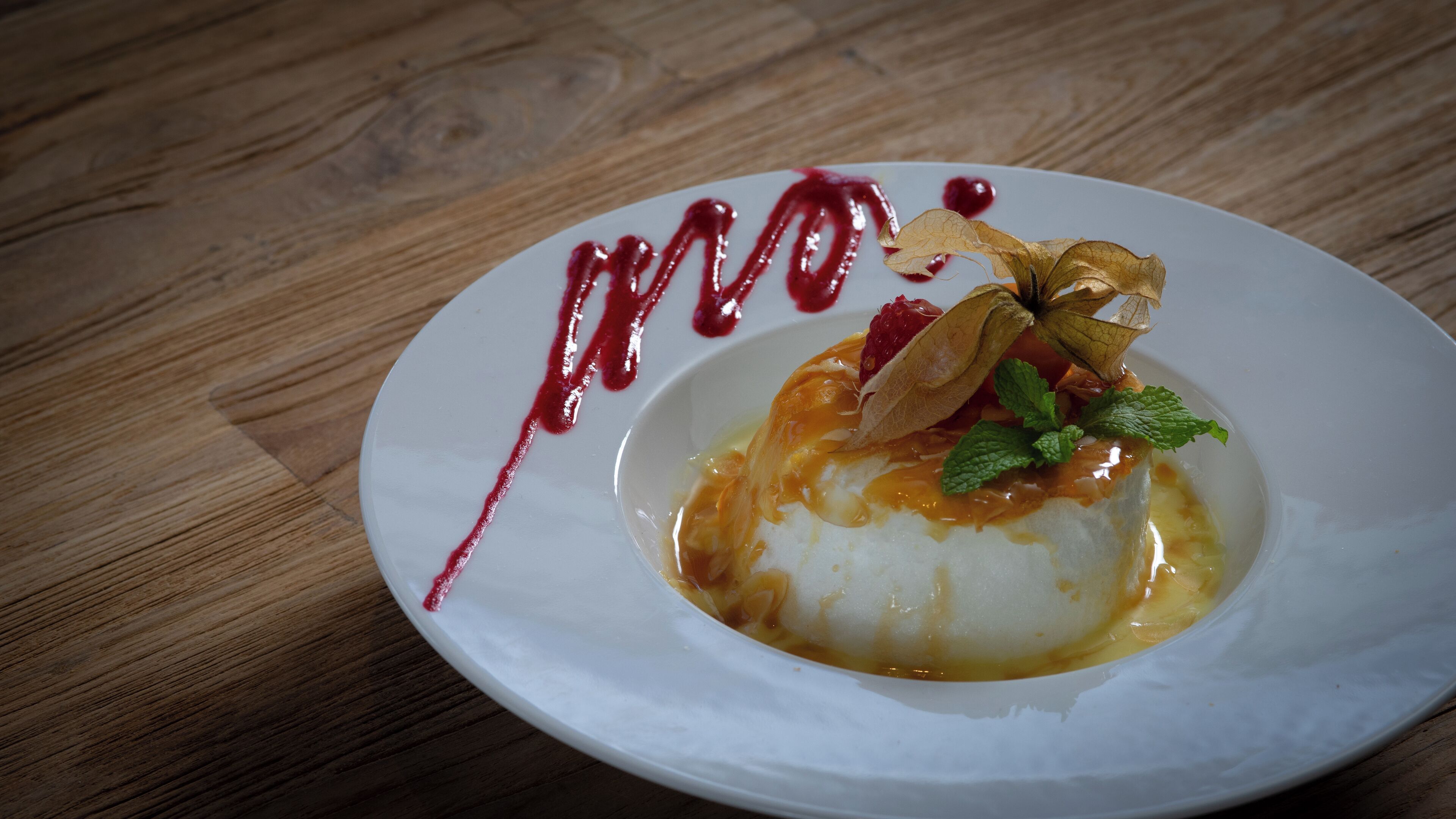 A dessert on a white plate with a wooden table background.