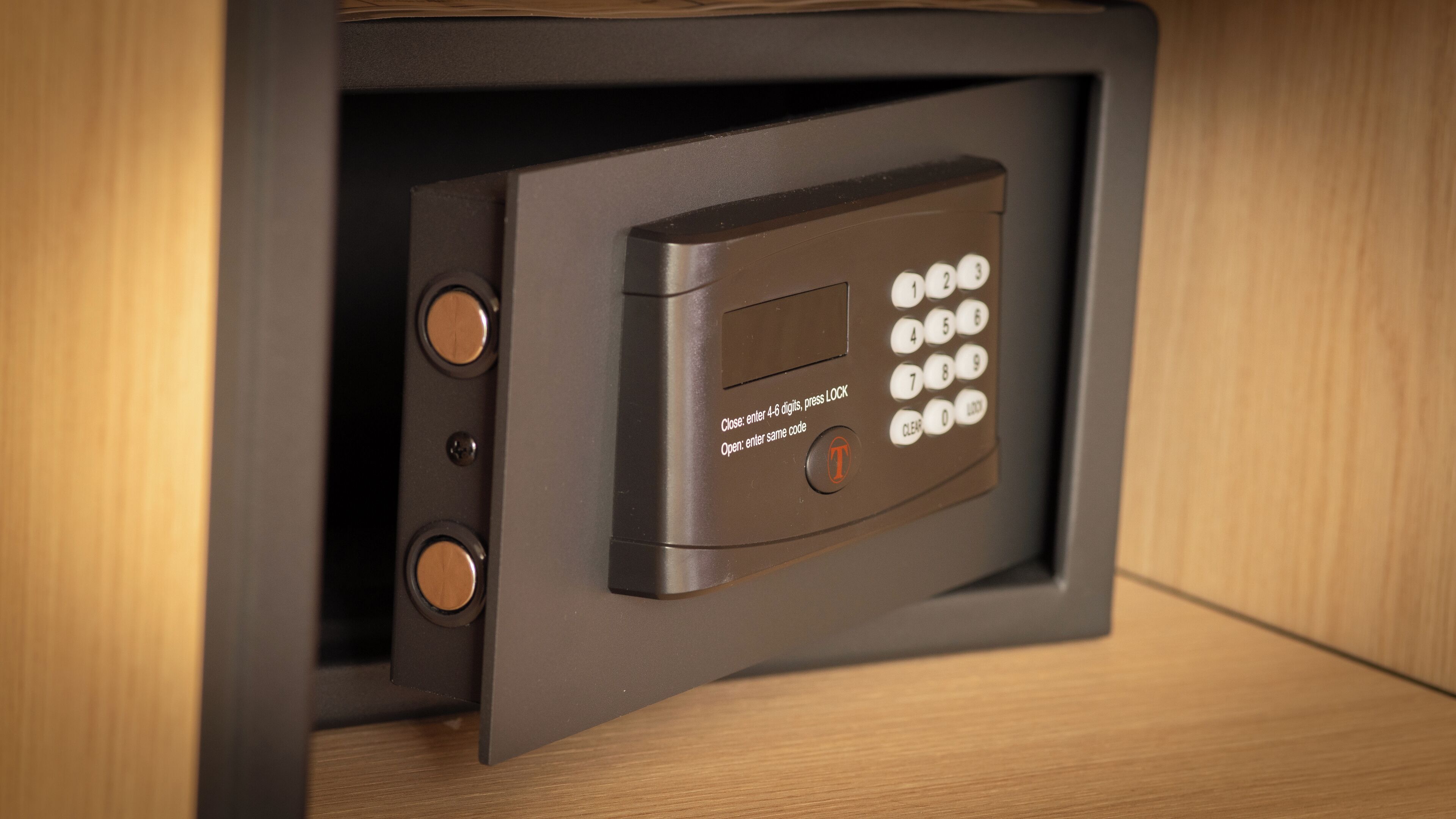 A safe with a keypad and a lock mechanism.