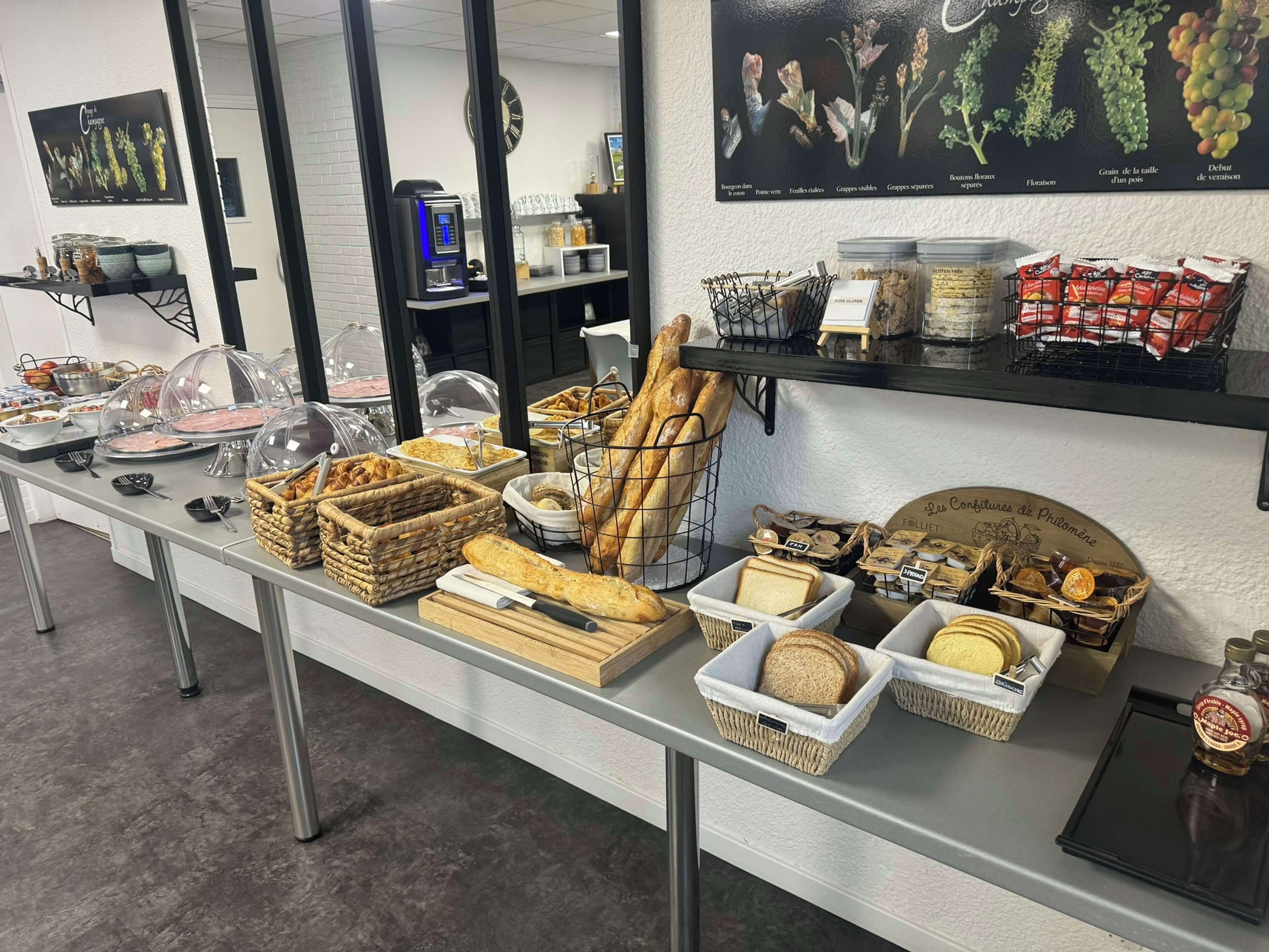 A buffet setup with various food items and a coffee machine.