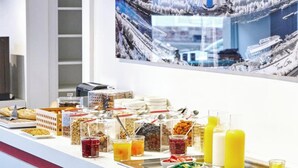 A buffet with various food items and beverages.