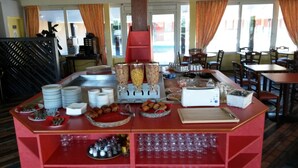 A buffet setup with various food items and condiments.