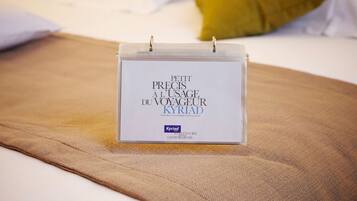 A small, clear, white box with text on a bed.