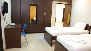A hotel room with two beds, a desk, and a chair. - Shylee Niwas Kodambakkam I (Chennai)