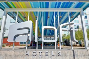 A hotel entrance with a colorful striped roof and the word "HOTELS" displayed prominently. - Aloft by Marriott Phoenix-Airport (Phoenix)