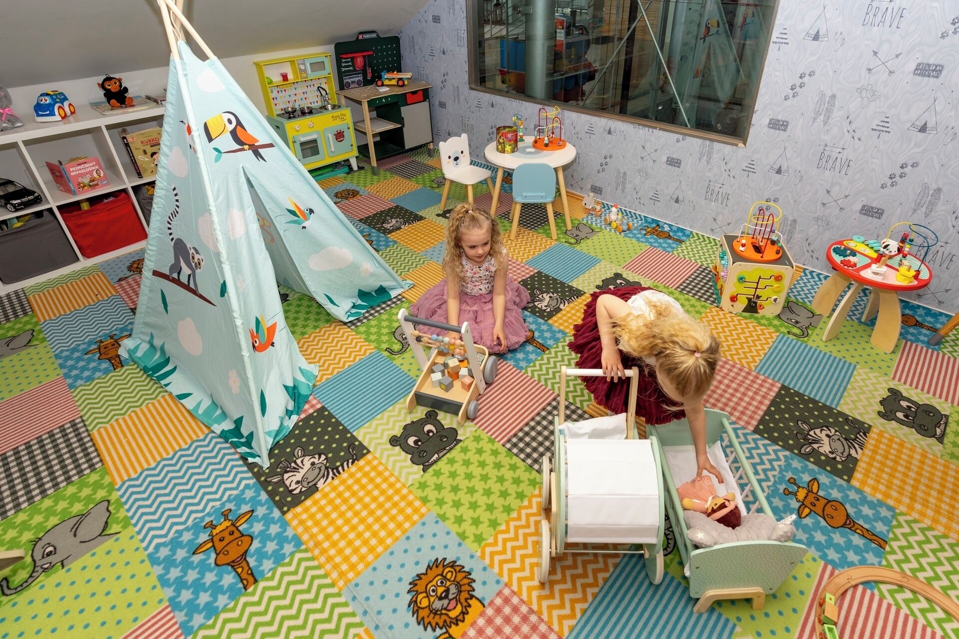 A child's playroom with a colorful floor, a play tent, and various toys and furniture.