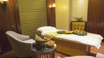 Relax in comfort with a massage table and two chairs, surrounded by a small table with a decorative bowl and tray.