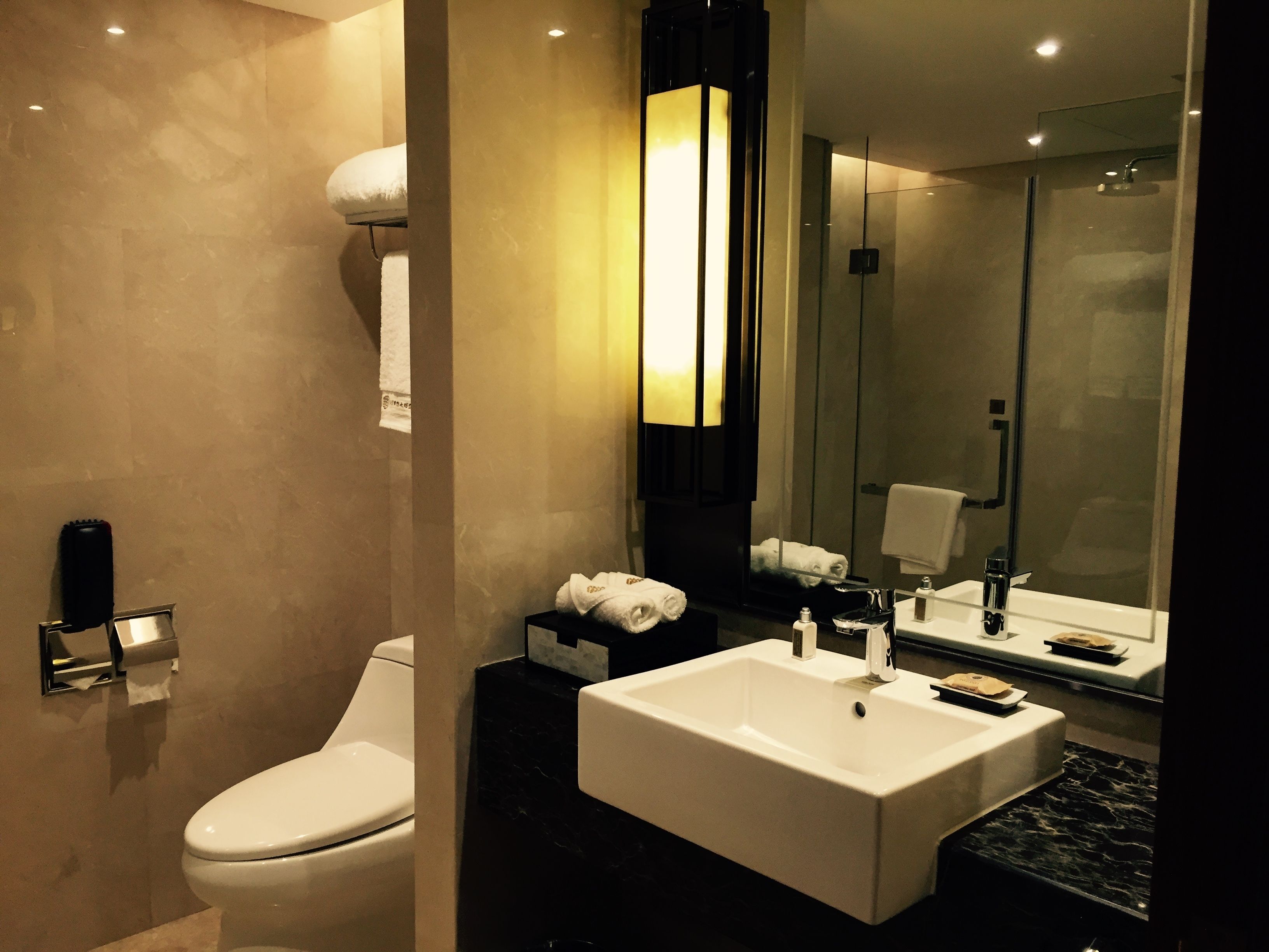 designer toiletries, hair dryer, slippers, towels