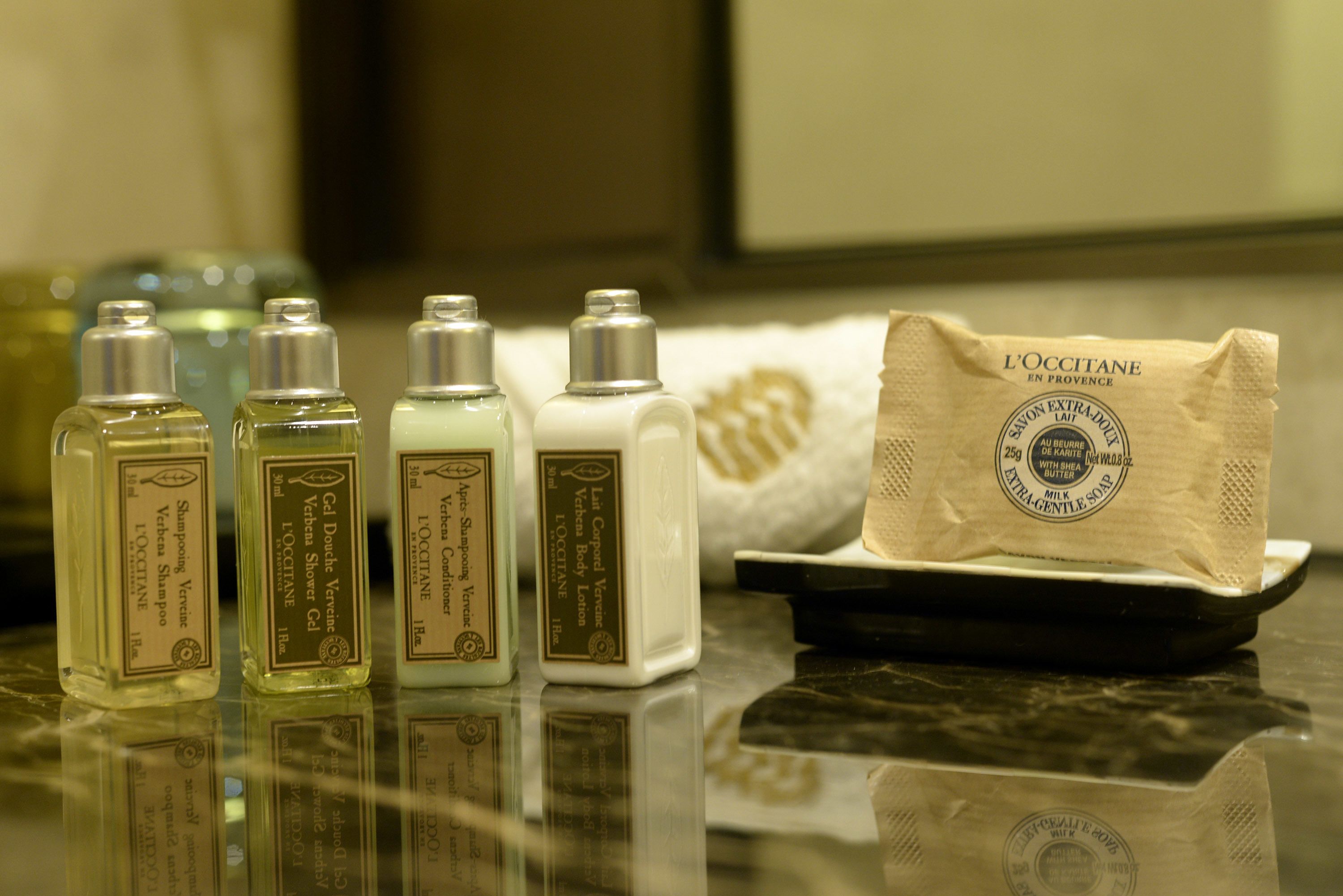 deluxe suite | bathroom | designer toiletries, hair dryer, slippers, towels